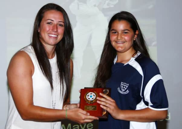 Ariana Dowse (right) receives her under-13 players' player of the year award