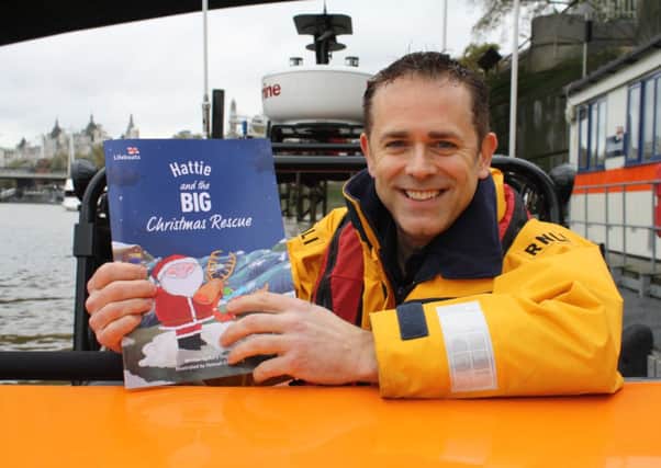 Chris Jarvis with the new personalised book raising money for the RNLI