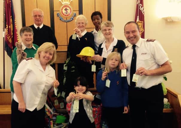Horsham Salvation Army Toy Appeal 2014 - Major Ann Stewart is (far left front) and Major Iain Stewart (far right front) with volunteers with some of the prenents already donated - picture submitted