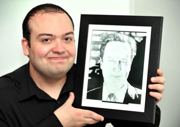 Paul Milton with his drawing of David Cameron. Pic Steve Robards SUS-141125-103408001