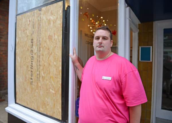 Mr Thompson, pictured outside his vandalised store, has appealed to MP Nick Gibb for help D14491590a