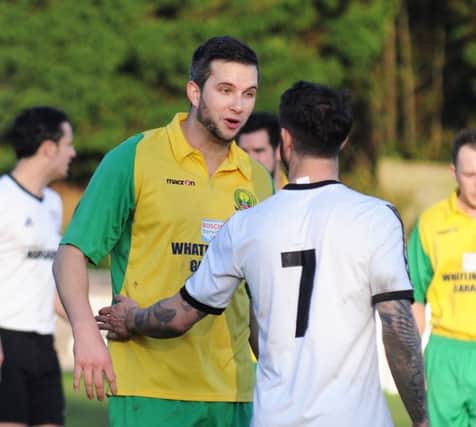 Bexhill United winger Andy Garman exchanges views with Westfield striker David Pugh at The Parish Field on Saturday. Picture courtesy Jon Smalldon