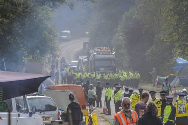 Police lead a fracking rig to Cuadrilla's Balcombe site amid protests
