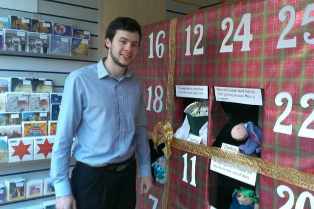 Rob Carter, manager of the Horsham Matters Eats Street shop opens the Nativity Advent calandar - picture by Anna Coe