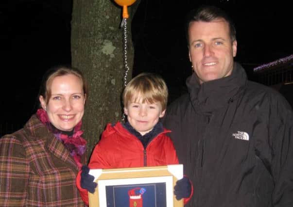 Proud parents, Alayne and Ben Fawkes, with competition winner Chester holding his framed picture SUS-140812-165705001