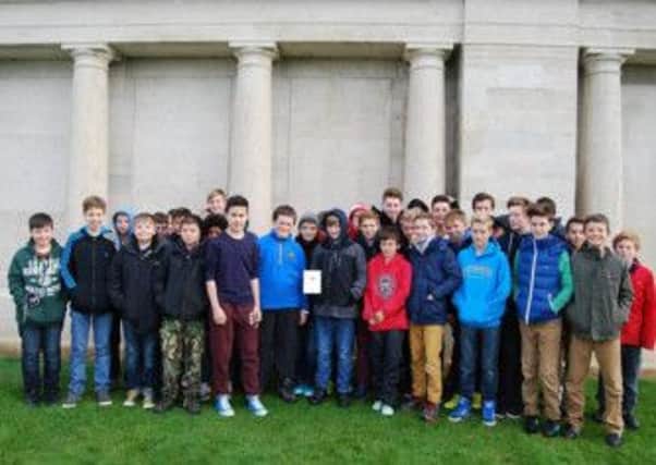 Visiting Albert (Jack) Dancy at Pozieres Memorial and leaving a plaque from The Forest School SUS-140912-170842001