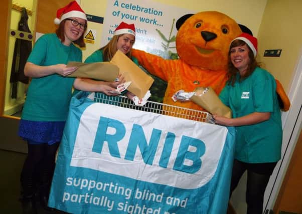 RNIB supporter Sooty is pictured collecting stamps with members of the fundraising team Carol McKinlay, Hannah Duggan and Nicky Butcher. SUS-141212-105407001