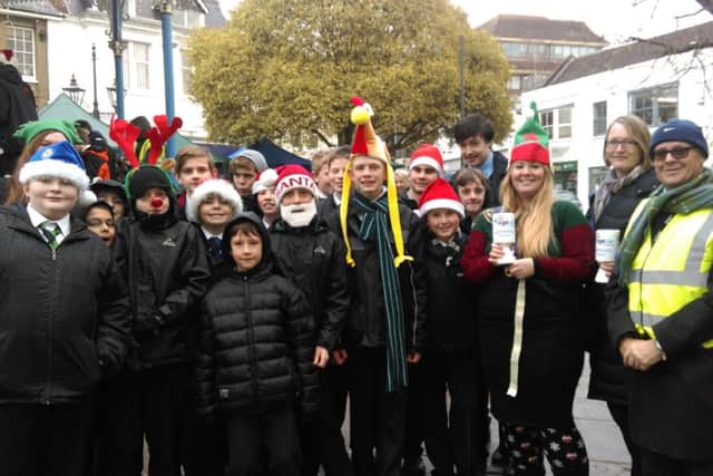 Forest School pupils support Age UK Horsham District by pperforming Christmas music on the Horsham bandstand