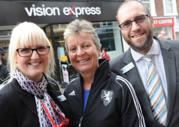 JPCT 191214 S14510366x Vision Express manager (left) and dispencing optician (right) with Sue Crake of Horsham Hockey -photo by Steve Cobb SUS-141219-114549001