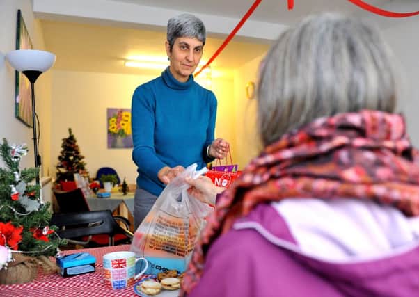 Sally Martin, who works at the food bank handing out food packages at their Haywards Heath shop. Pic Steve Robards SUS-141215-142835001
