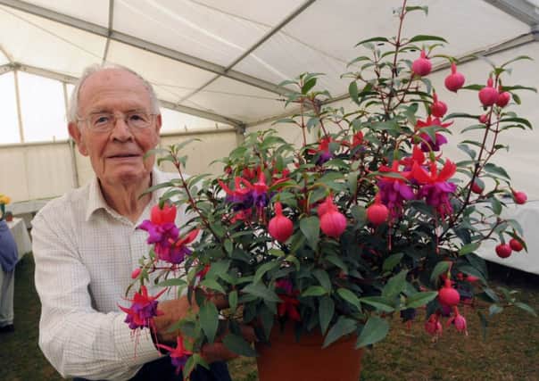 Glyn Allen, pictured with his prize-winning fuchsias at the 2011 Littlehampton Town Show. He was among those who helped to bring back the event