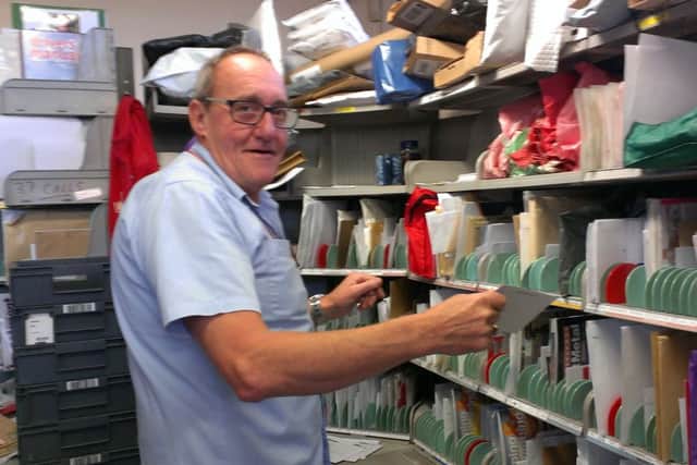 Horsham postie Tony Crawte sorting Christmas mail at the Horsham Delivery Office - picture by Anna Coe