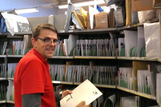 Postman Peter Athersmith busy in Horsham Delivery Office - picture by Anna Coe