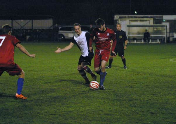 Luke Gedling for YM (centre/white) in action. Photo by Clive Turner