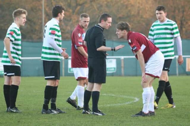 Hastings United striker Evan Archibald is spoken to by the referee during last weekend's 2-1 defeat away to Chipstead. Picture courtesy Joe Knight