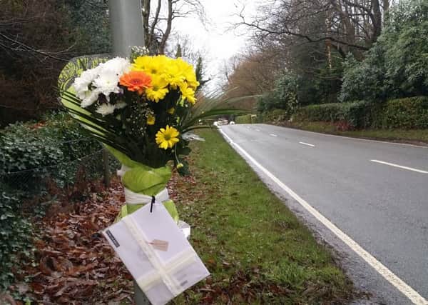 Floral tributes at scene of collision where the car crashed