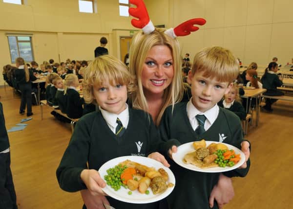 W51522H14

Christmas Lunch at the Vale  School Findon Valley on Thursday Supervisor Emily Chatterton serves the meal SUS-141218-160924001