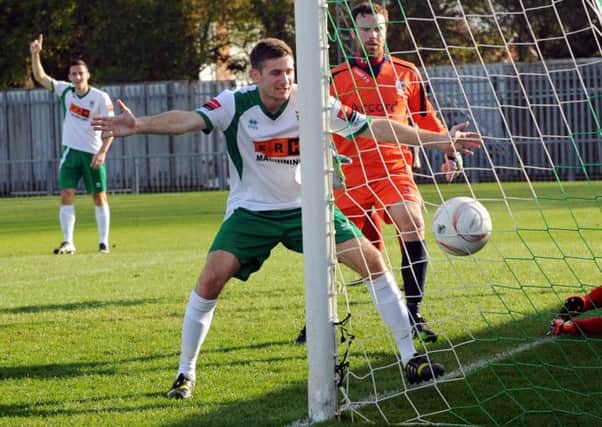 Jason Prior - in the background - watches as James Crane sees in Prior's first goal on his return to Bognor  Picture by Louise Adams