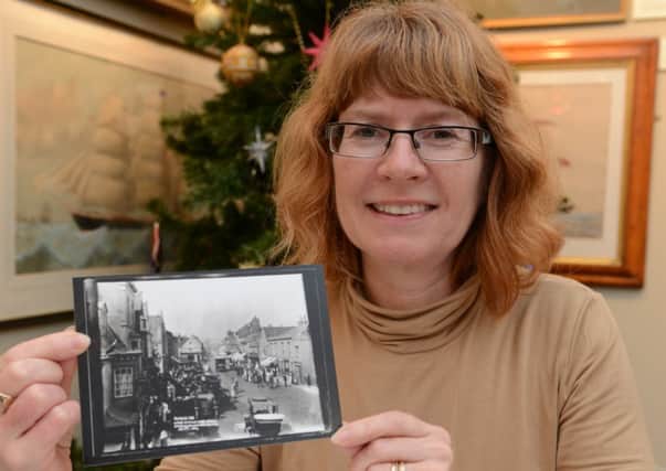 Julie Wade with one of the photos she found in the Marlipins Museum archives D14501738a