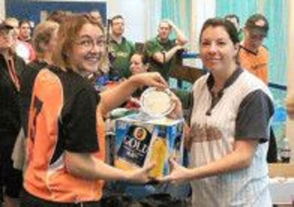 Falcon Lucy Morris receives the plate trophy from Beachcomber Rochelle Entickna