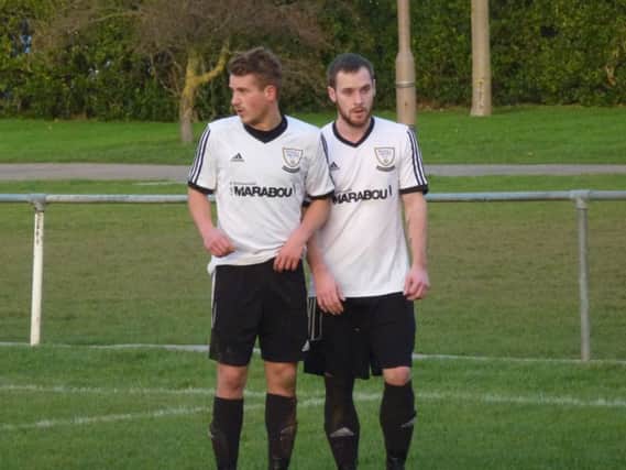 Chris Cumming-Bart (left) and Allan McMinigal form a two-man defensive wall during Bexhill United's 4-0 win at home to Seaford Town on Saturday. Picture by Simon Newstead (SUS-141221-121809002)