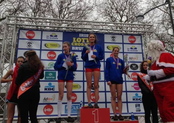 Grace Baker stands proudly on top of the podium after her victory at the Lotto Cross Cup in Belgium last weekend