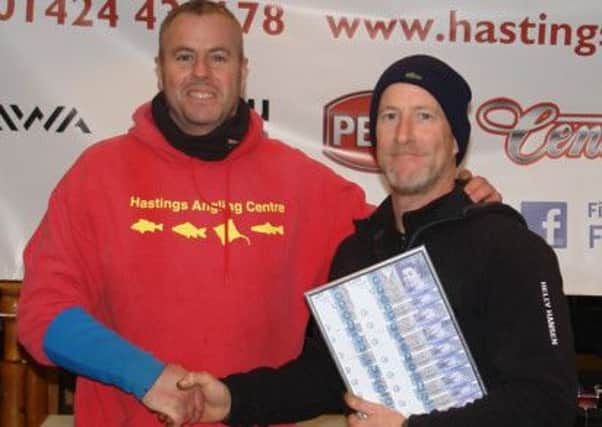 Hastings Angling Centre Open winner Chris Snow (right) receives his cash prize