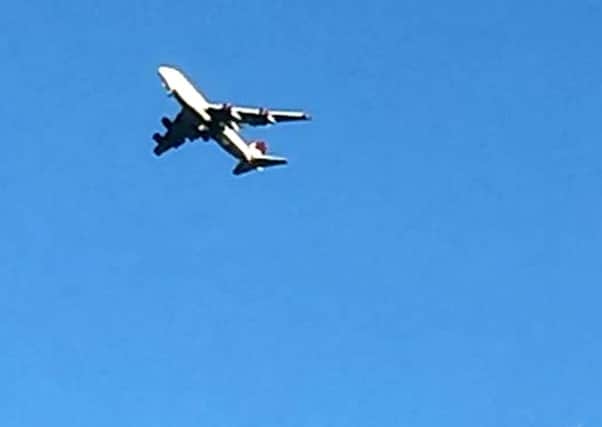 A Virgin 747 is seen circling over Sussex, December 29 2014 after it developed a problem with its landing gear. Initial reports suggest one side of the landing gear is not deployed on the Gatwick to las Vegas flight. See SWNS story SW747 SUS-141229-152923001