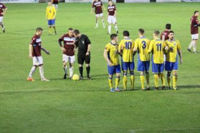 Hastings United line up a free kick during their narrow defeat at home to Burgess Hill Town on Saturday. Picture courtesy Joe Knight
