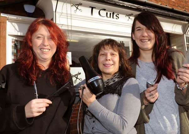 JPCT 130114  Tracy Bassett, left, owner of T Cuts hair salon, Horsham is donating a day's takings to charities once a month this year. Pictured with stylists Dom Berwick (middle) and Marisa Campbell. Photo by Derek Martin ENGPPP00320140113155102