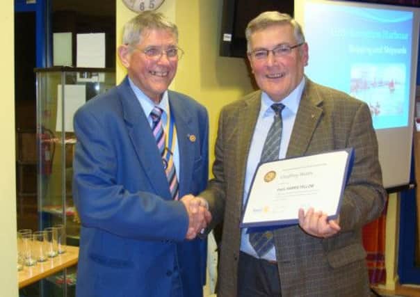 Geoffrey Watts receives his award from Rotary president, John Mitchell, right