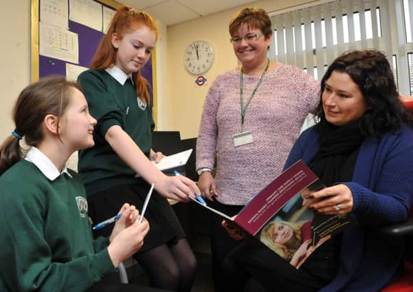 Year-six pupils Erin Stoddart, left, and Bethany Green interview Luisa Gould, executive head teacher, and Yvonne Brailsford, head of school  L02703H14