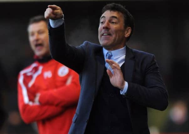 Dean Saunders the new Crawley Town manager watches his side against Colchester (Pic by Jon Rigby) SUS-141228-182307002
