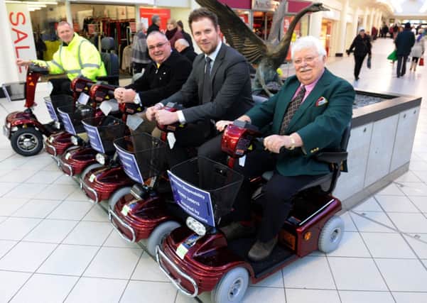 JPCT 140115 S15030088x Sussex Freemasons donate shopmobility scooters to Swan Walk Shopping Centre -photo by Steve Cobb SUS-150114-112714001