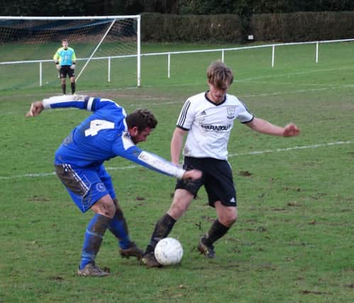 Jamie Crone in the thick of the action for Bexhill United during their 3-1 defeat away to Midhurst & Easebourne last weekend. Picture courtesy Mark Killy