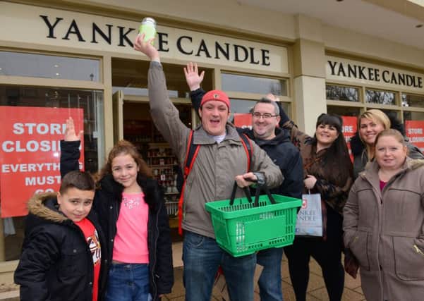 Adam Terry, third left, leads the spending spree rally at Yankee Candel D15031134a