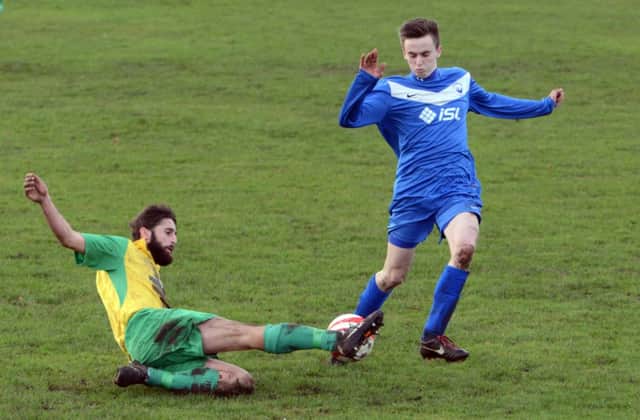 Ashley Paine slides in to a tackle during Westfield's 3-1 win away to Storrington on Saturday. Picture by Derek Martin (SUS-150118-212652002)