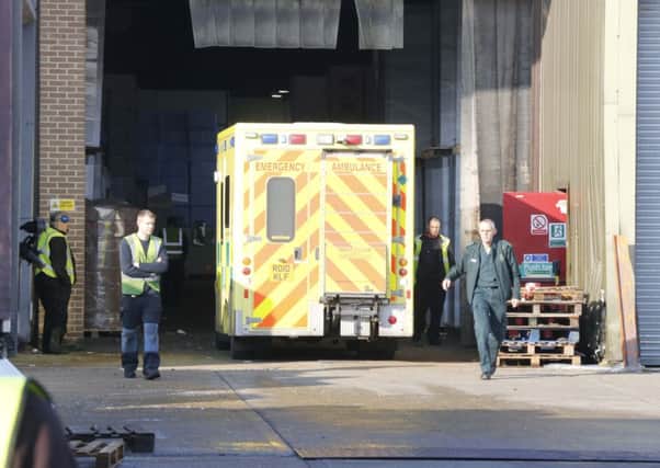 Paramedics help to treat the man who fell 30ft through a skylight on the roof  PHOTO: Eddie Mitchell SUS-150122-140643001