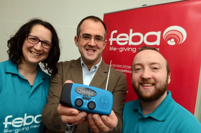WH 230115 Feba,  Worthing, donating radios to Africa in fight against Ebola. L to R Hannah Clark, (relationship manager),  Bob Chambers (chief Executive) and Francis Miles Video communication officer. Photo by Derek Martin SUS-150123-114536001
