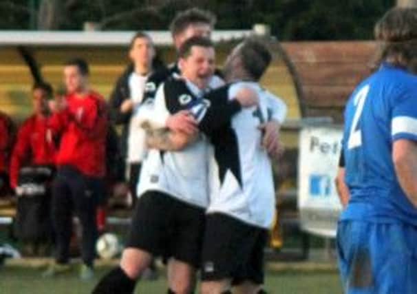Pagham players celebrate their late winner   Picture by Roger Smith