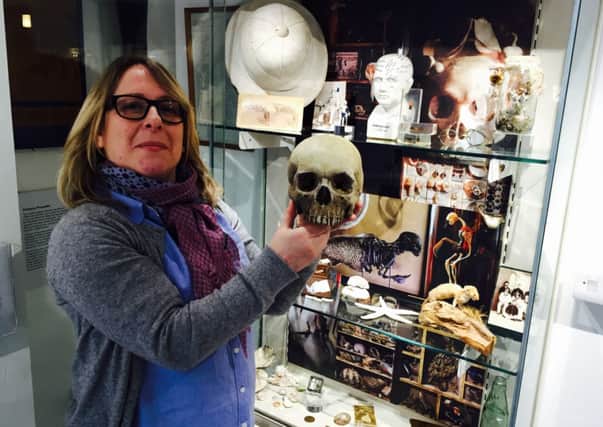 Jessica Petit, curator at the Rustington Museum, with some of the relics at the new cabinet of curiosity display SUS-150122-150513001