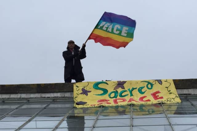 Campaigner on the roof of the Meadview Centre, in Lyminster, to avoid bailiffs SUS-150129-190720001