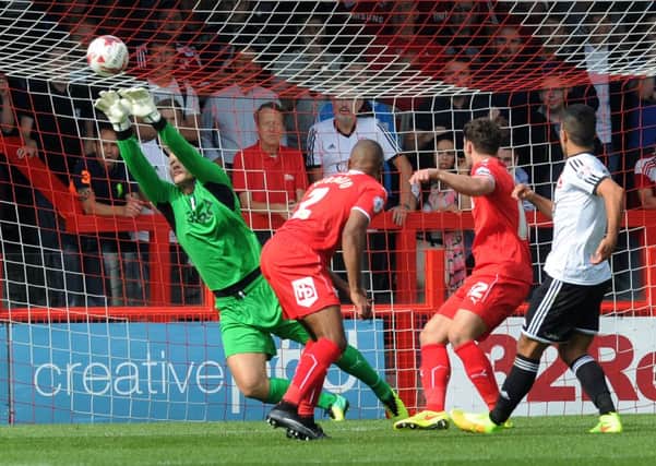 Crawley Town's keeper Brian Jensen makes another fine save against Swindon (Pic by Jon Rigby) SUS-140818-143852002