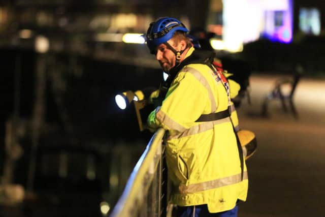 One of the coastguards using a torch to search the river PHOTO: Eddie Mitchell