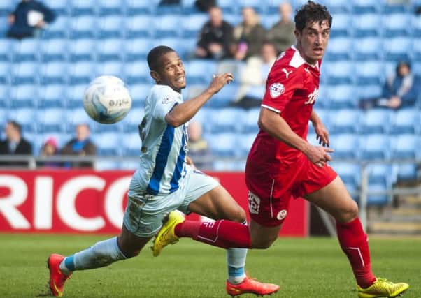 Coventry City V Crawley Town pic by Jason Skarratt 4/10/14
Simeon Jackson cehases the ball with Joe Walsh , action from todays game at the Ricoh Arena SUS-140710-110255002