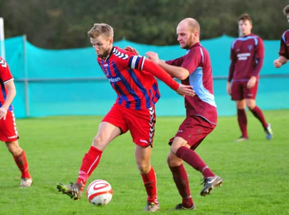 Little Common player-manager Russell Eldridge (right) in the thick of the action during the 4-0 victory at home to Wick & Barnham United (SUS-141113-180006002)