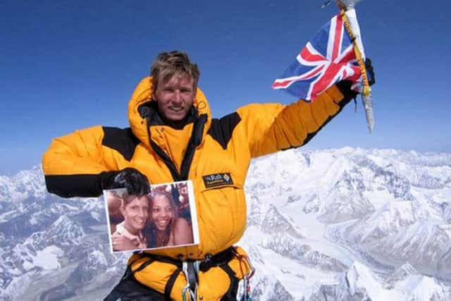 Rob Gauntlett who died in the Alps pictured on the summit of Mount Everest holding a picture of himself with girlfriend Lucinda Hutchins, 21 -  Handout/PA Wire