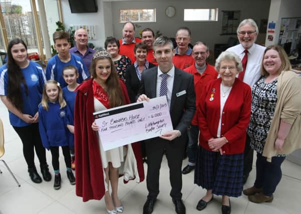 Jessica Baker, Miss Bonfire 2014, presents the cheque to Neil Francis, community fundraising manager at St Barnabas HousePicture by Derek Martin  D15091089a