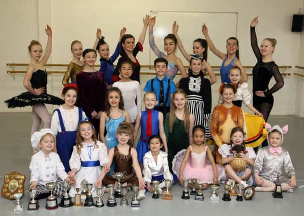 Dance Industry's crop of talent young pupils showing off their trophies and medals