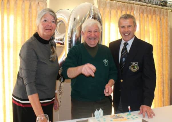 George with captains Kathy Honeysett and Mark Gerken cutting the cake